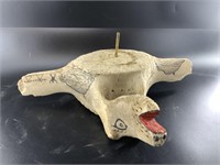 Whalebone vertebrae with carving depicting moose a