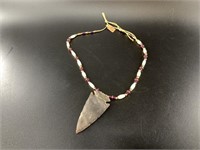 Modern stone spearhead on a nice strand of brass,