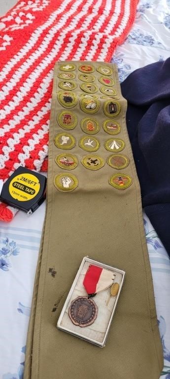 vintage Boy Scout sash with badges and a pin