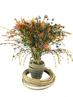A Faux Wildflower Floral Arrangement In Rope