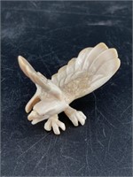 Fossilized ivory bald eagle in a striking pose, ve