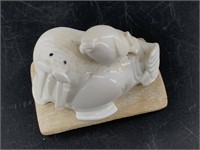 A.H.S. ivory carving of a mother walrus and her cu