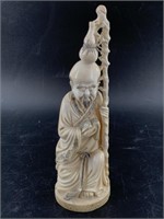 Antique ivory carving of a wise man with traveling