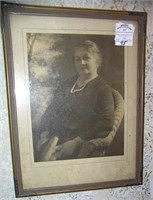 Antique photograph of a woman in a wicker chair