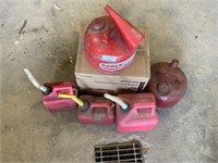 5 assorted gas cans. 2 are metal.