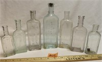 7 Antique Embossed Medicine Bottles - LOOK!