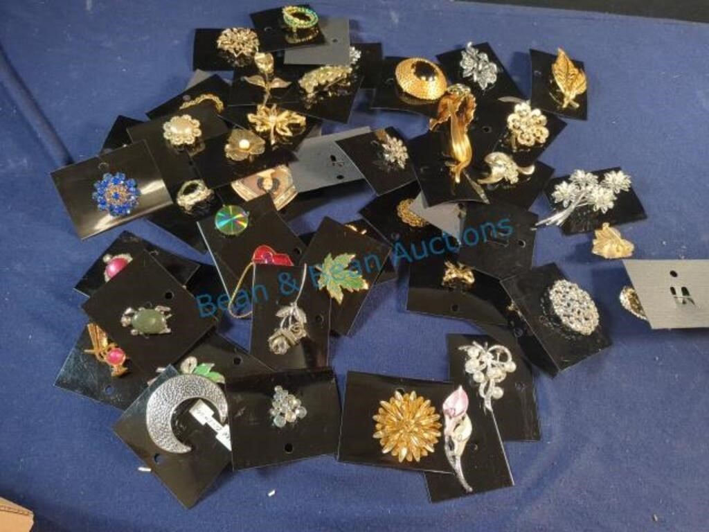 Brooches and pins on cards
