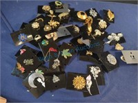 Brooches and pins on cards