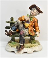 CAPODIMONTE STYLE MAN DRINKING ON BENCH FIGURINE