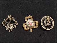 3 vintage small brooches. One on right is marked