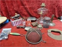 Primitive utensils, oil lamp, glasses, scoop.