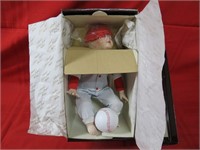 Porcelain baby doll in box.