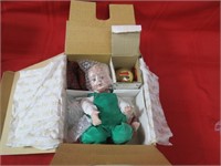 Porcelain baby doll in box.