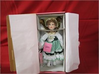 Porcelain doll in box.