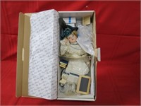 Porcelain doll in box.