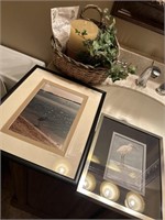 Pictures and basket with fake leaves and candle