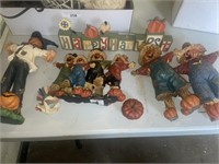 Resin scarecrows and happy harvest sign