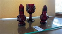 Two red engraved Avon salt and pepper shakers,
