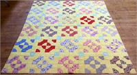 Vintage hand stitched yellow background quilt