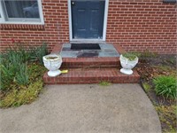 Pair Of Cement Flower Pots Located On Front Step