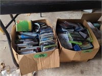 Boxes Of Dvds, Cds Etc. Located Under Table
