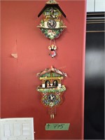 Two Small Cuckoo Clocks Located On Wall