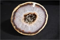 Polished geode with gold miners inside