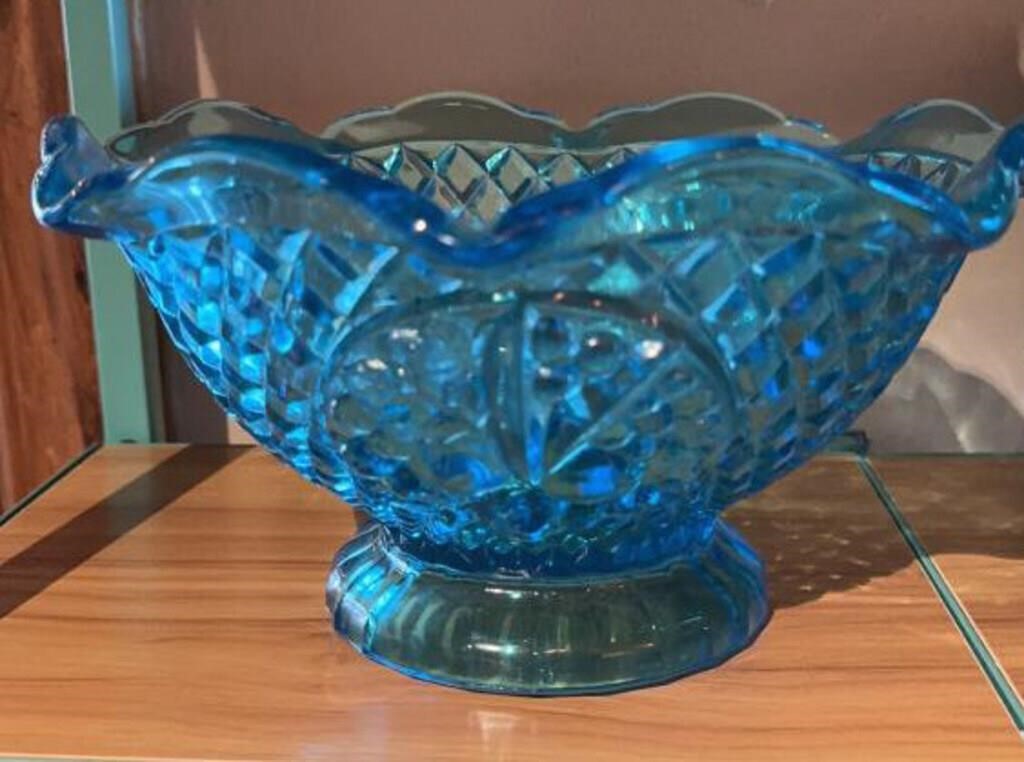 Blue glass pedestal bowl with ruffled edge