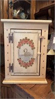 Wall hanging cabinet with swan picture