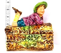 Vintage trinket box with lady laying on log