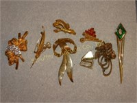 8 Gold tone brooches