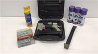 Tool lot: purple spray paint, nail gun,