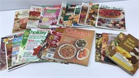Lot of cooking magazines and small cookbooks.