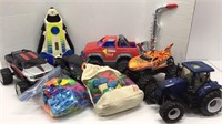 Toy lot: large toy trucks, instrument, play-doh