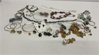 Silver toned necklaces and various pierced ear