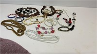 Various beaded necklaces, (1) brass necklace, (2)
