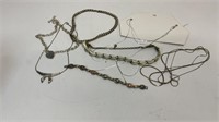 Silver toned jewelry, (6) necklaces and (1)