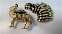 Camel and zebra pins, both gold tone