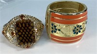 2 cuff bracelets, gold tone, orange enamel with