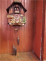 Decorated and carved cuckoo clock with revolving