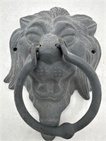 Metal lion head door knocker