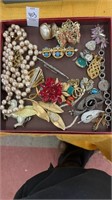 Small box of costume jewelry and pins