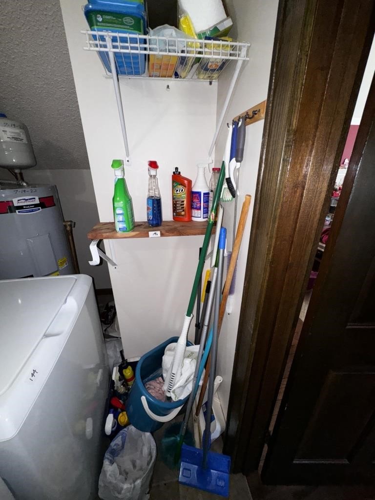 MOPS BROOMS AND ITEMS ON SHELF IN LAUNDRY ROOM