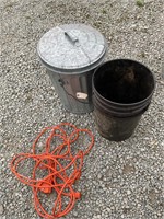 Metal trashcan, a bucket and extension cord