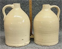 (2) stoneware jugs.  1 is chipped and has a slight