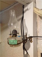 Vintage kerosene lamp on wall bracket bring flat