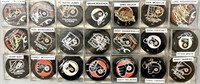 21 Autographed hockey pucks as pictured