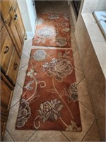 Pair of peach colored rugs