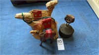 Three hand man camel toys and a wooden carving