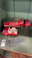Two vintage Coca-Cola trucks, and one ramp